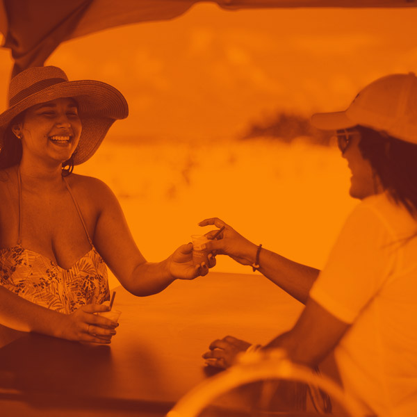 Customers taste beverages at promo event at the beach